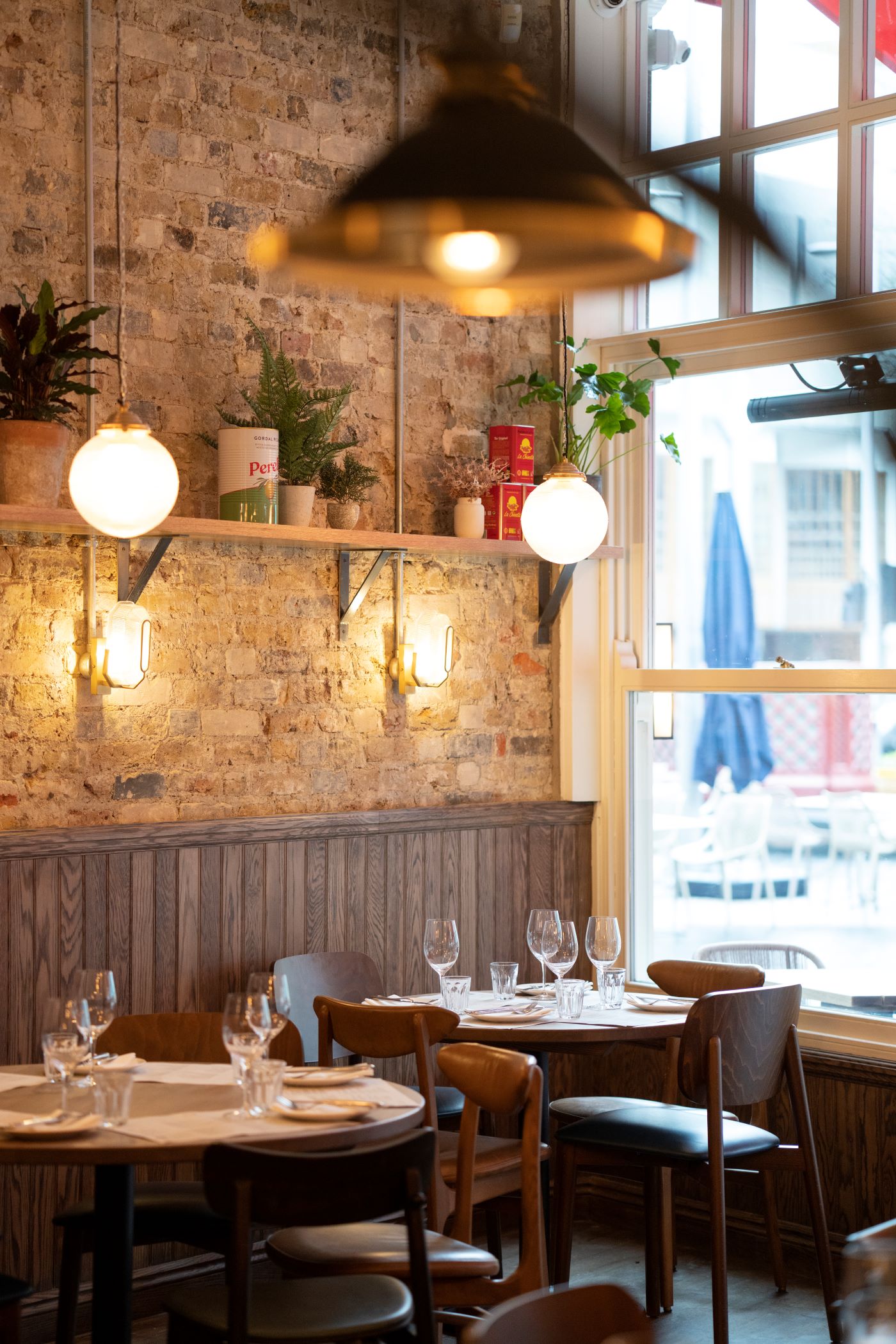 Two tables set by the window 