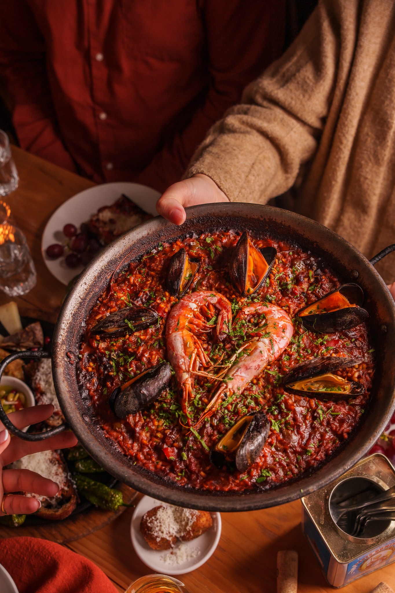 Someone holding a seafood paella at Brindisa Tapas